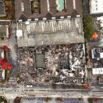 A top-down drone view of the burned down complex