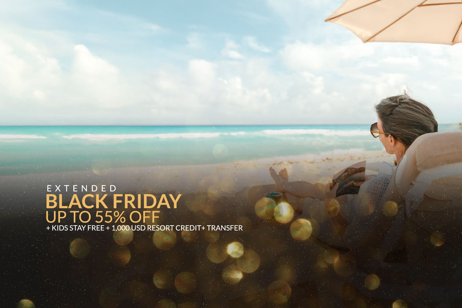 a woman sitting under an umbrella on a beach