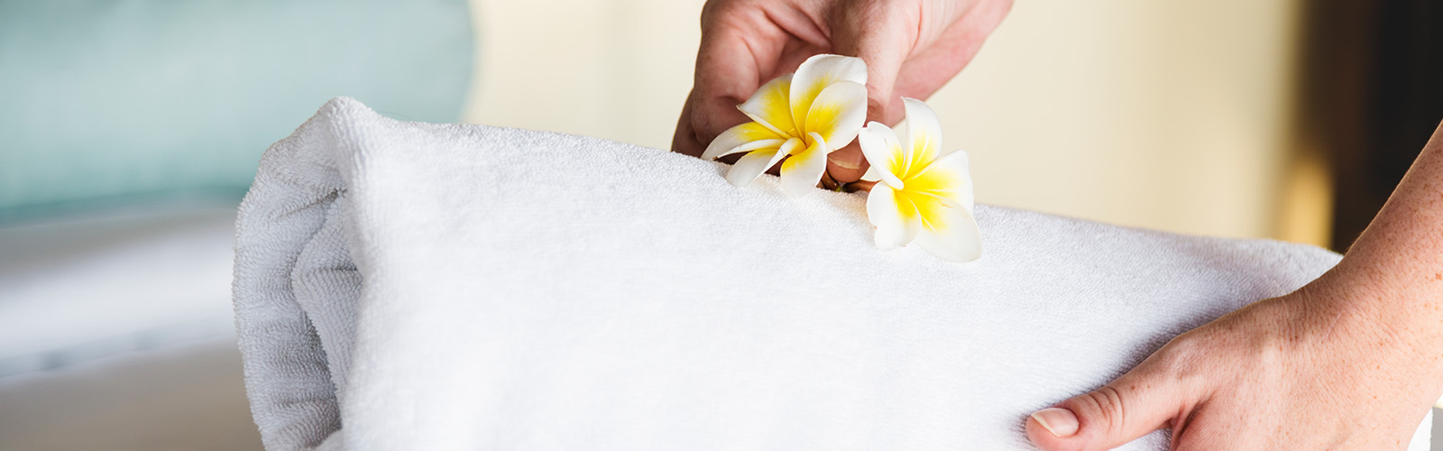 a person holding flowers on a white towel