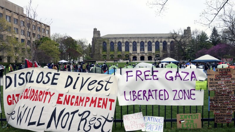 Signs are displayed outside a tent encampment at Northwestern University on Friday, April 26, 2024, in Evanston, Illinois.