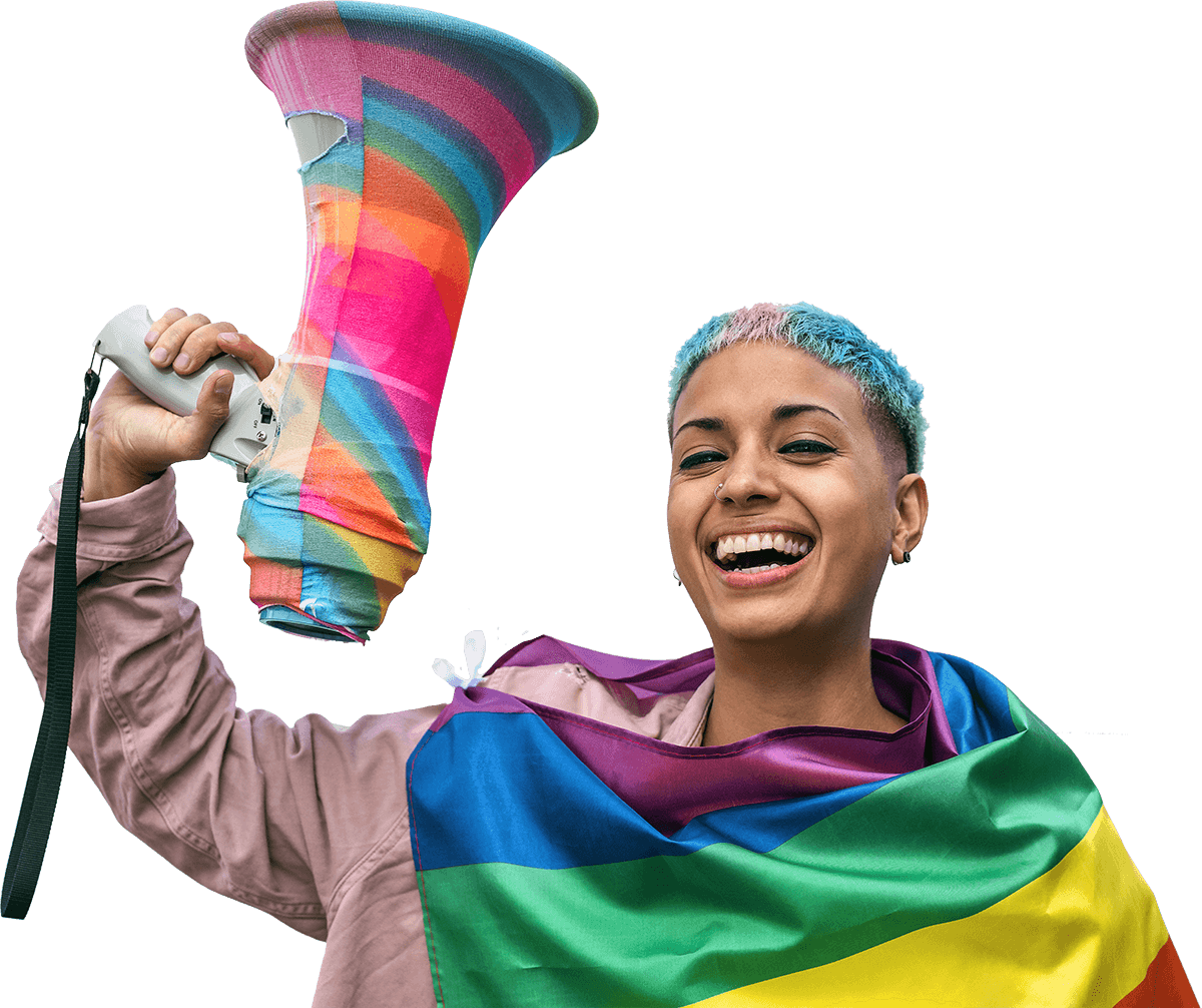 Smiling person holding a colorful megaphone and draped in a rainbow flag