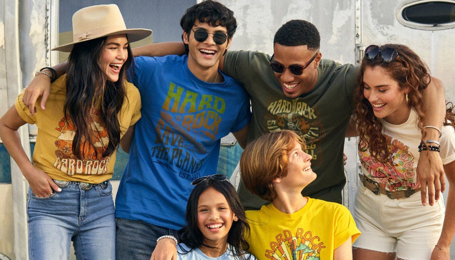 group of young people each wearing a different Hard Rock tee